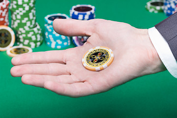 Image showing poker chips in the palm of a man