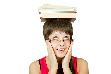 Image showing girl in glasses with books on head