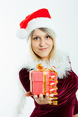 Image showing beautiful blonde in a Christmas hat with gifts