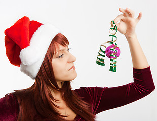 Image showing girl in a Christmas hat with a decoration