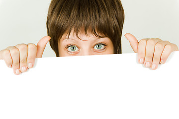 Image showing girl hiding behind a white banner