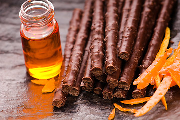 Image showing chocolate sticks with orange