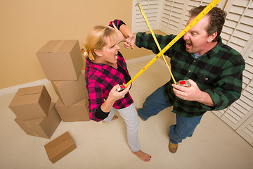 Image showing Couple Having Fun Sword Fight with Tape Measures