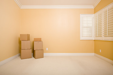 Image showing Moving Boxes in Empty Room with Copy Space on Wall