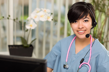 Image showing Attractive Multi-ethnic Woman Wearing Headset, Scrubs and Stetho