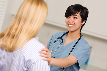 Image showing Attractive Multi-ethnic Young Female Doctor Talking with Patient