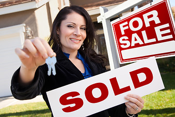 Image showing Hispanic Woman Holding Sold Real Estate Sign and Keys in Front H