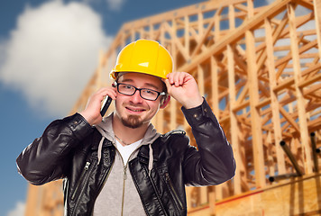 Image showing Young Cunstruction Worker on Cell Phone In Front of House