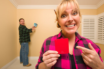 Image showing Couple Comparing Paint Colors in Empty Room