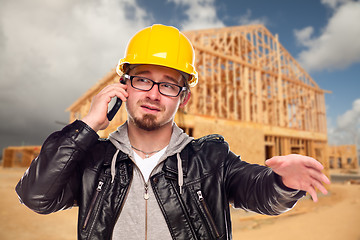 Image showing Young Cunstruction Worker on Cell Phone In Front of House