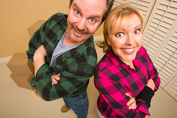 Image showing Proud Goofy Couple and Moving Boxes in Empty Room