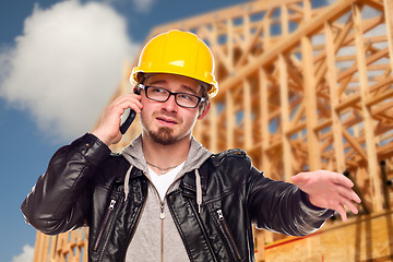 Image showing Young Cunstruction Worker on Cell Phone In Front of House
