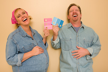 Image showing Pregnant Laughing Couple Deciding on Pink of Blue Wall Paint
