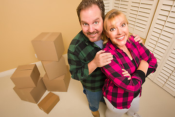 Image showing Proud Goofy Couple and Moving Boxes in Empty Room