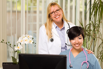 Image showing Smiling Mixed Race Female Doctors or Nurses in Office Setting