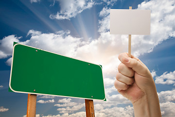 Image showing Blank Green Road Sign and Man Holding Poster on Stick 