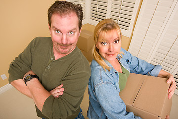 Image showing Goofy Couple and Moving Boxes in Empty Room