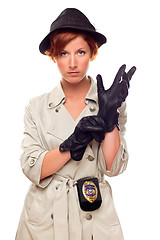Image showing Red Haired Female Detective Putting on Gloves Wearing a Trenchco
