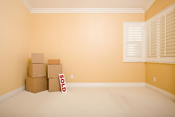 Image showing Moving Boxes and Sold Real Estate Sign on Floor