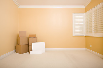 Image showing Moving Boxes and Blank Signs on Floor in Empty Room 