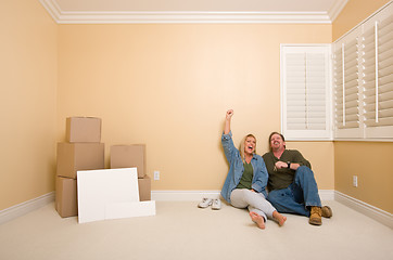 Image showing Couple on Floor Near Boxes and Blank Signs