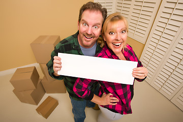 Image showing Happy Couple Holding Blank Sign in Room with Packed Boxes