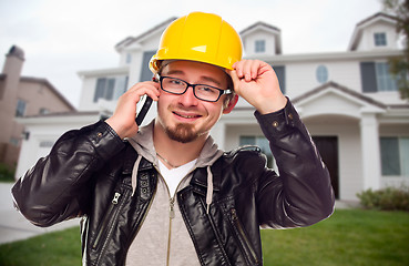 Image showing Contractor Wearing Hard Hat on Phone In Front of House