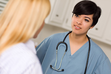 Image showing Attractive Mixed Race Young Female Doctor Talking with Patient