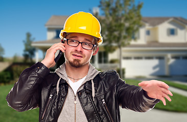 Image showing Contractor Wearing Hard Hat on Phone In Front of House