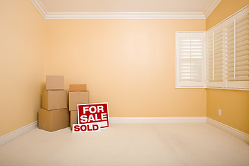 Image showing Boxes, Sale and Sold Real Estate Signs in Empty Room