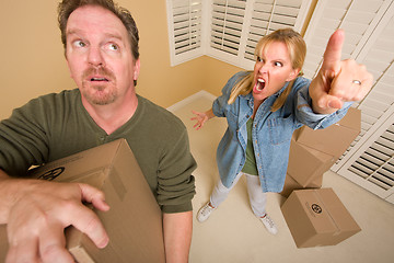Image showing Stressed Man Moving Boxes for Demanding Wife