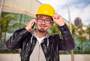 Image showing Young Cunstruction Worker on Cell Phone In Front of Building