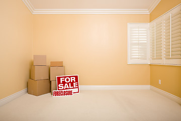 Image showing Boxes, Sale and Foreclosure Real Estate Signs in Empty Room