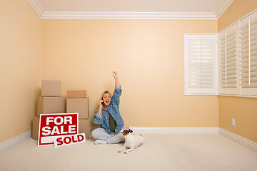 Image showing Sold Real Estate Signs, Boxes and Happy Woman on Phone