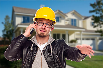 Image showing Contractor Wearing Hard Hat on Phone In Front of House