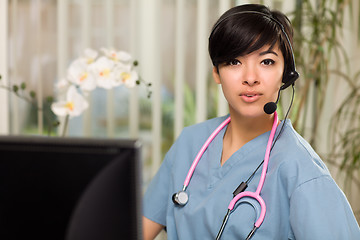 Image showing Attractive Multi-ethnic Woman Wearing Headset, Scrubs and Stetho