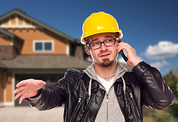 Image showing Contractor Wearing Hard Hat on Phone In Front of House