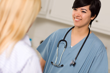 Image showing Attractive Mixed Race Young Female Doctor Talking with Patient