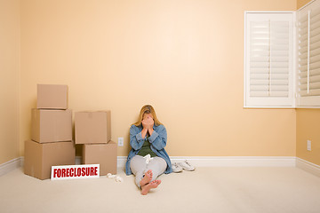 Image showing Upset Woman on Floor Next to Boxes and Foreclosure Sign