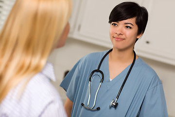 Image showing Attractive Mixed Race Young Female Doctor Talking with Patient