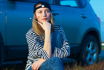 Image showing Young Blond Woman With Her Broken Car