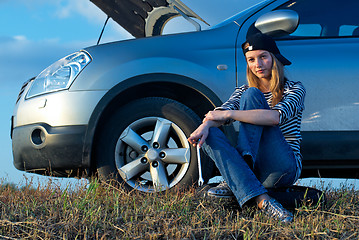 Image showing Young Blond Woman With Her Broken Car