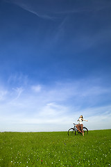 Image showing Girl with a bicycle