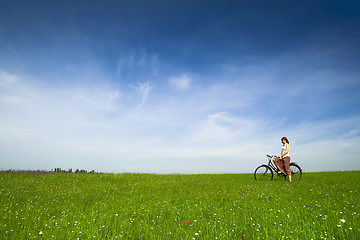 Image showing Girl with a bicycle