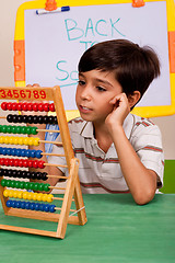 Image showing A student solving a math assignment