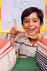 Image showing Smiling young student pointing up