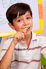 Image showing School boy enjoying his lunch meal