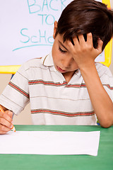 Image showing Little boy has troubles with homework