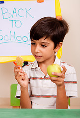 Image showing Young kid holding an apple