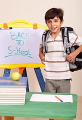 Image showing Schoolboy with books and backpack